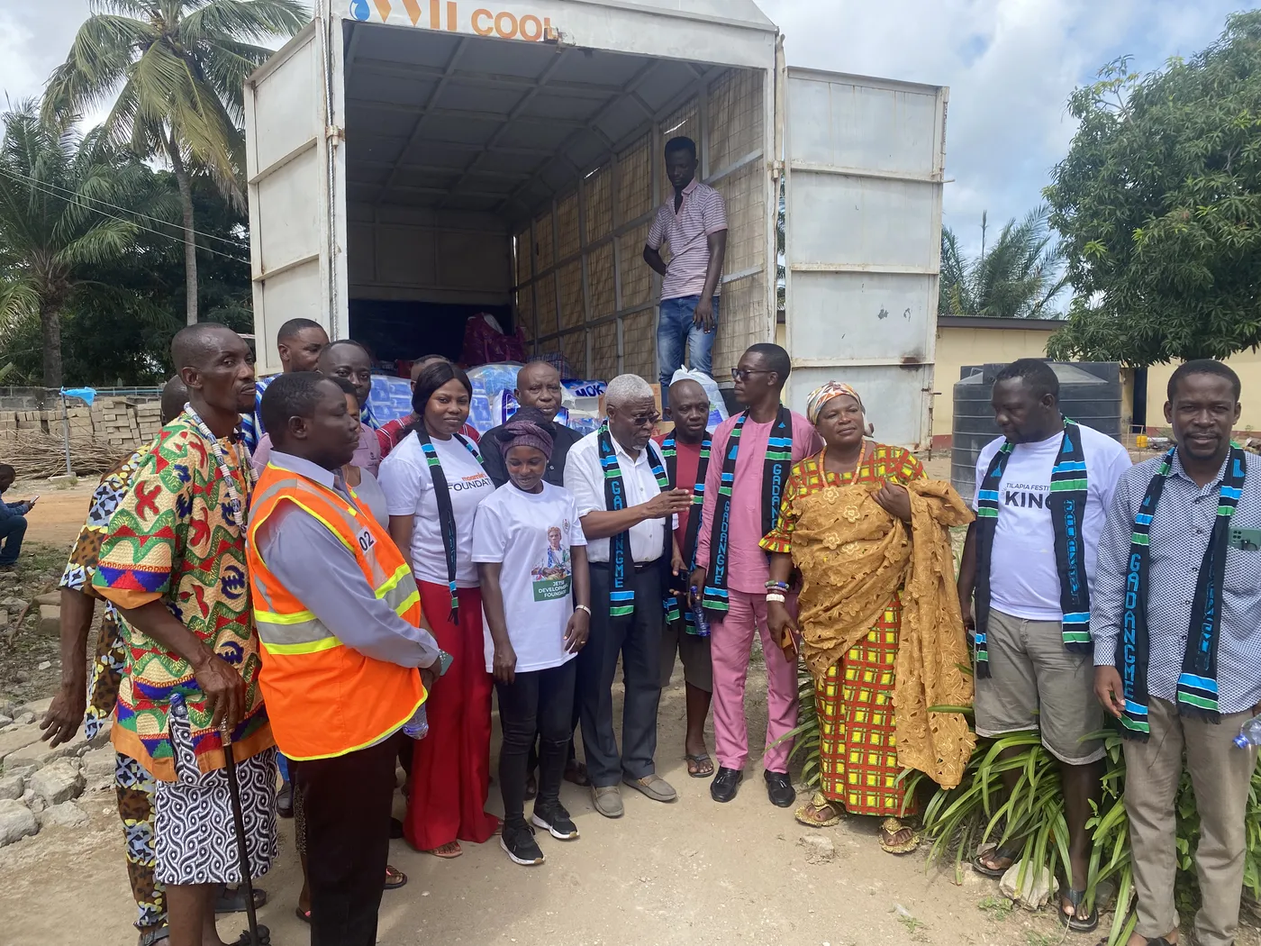 The MK Foundation team and a community chief beside a truck loaded with donations